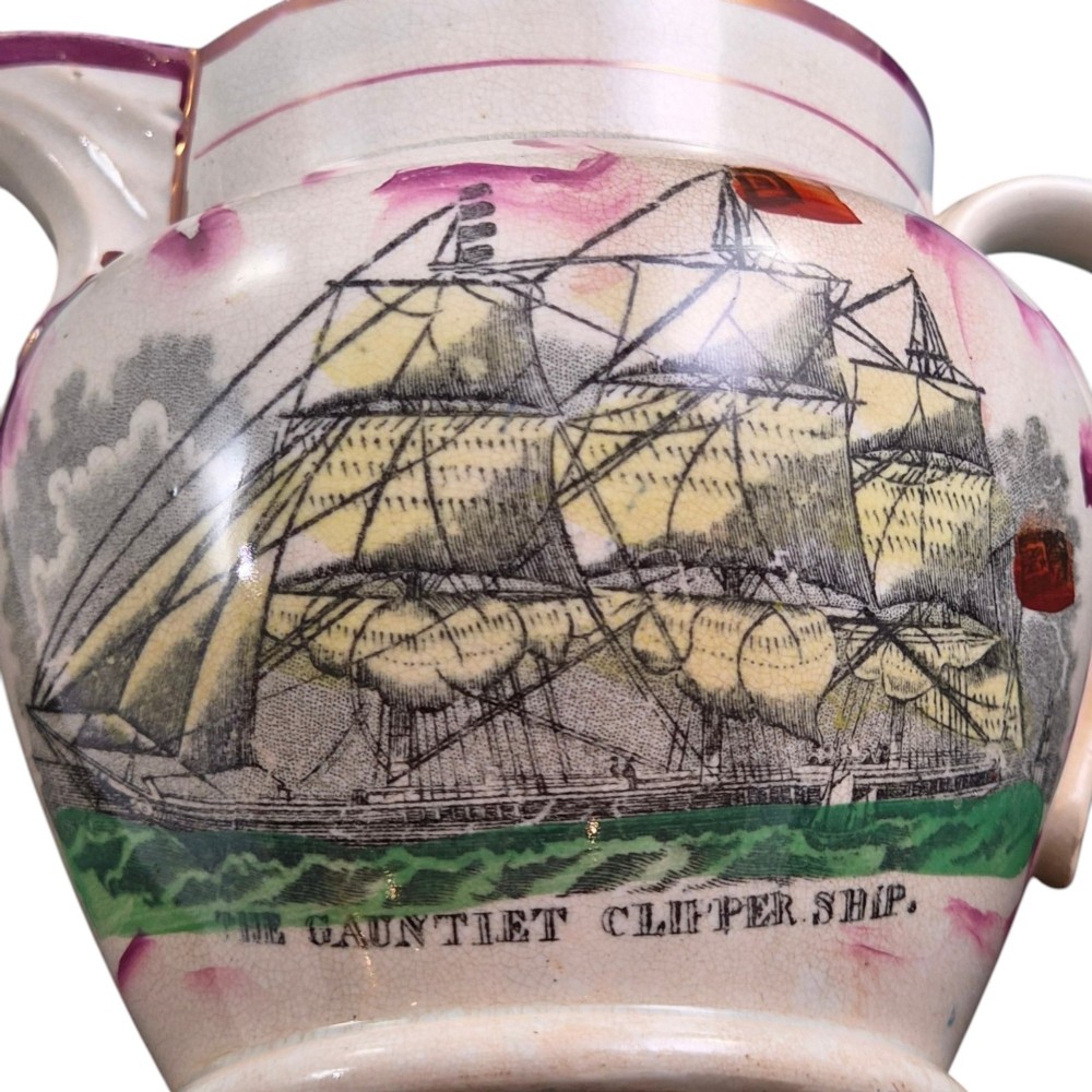 An antique cream earthenware jug featuring pink splash lustre decoration and a hand-coloured transfer print of Masonic coats of arms. View VI