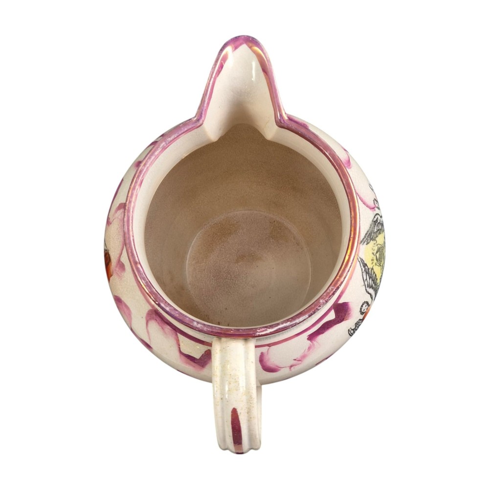 An antique cream earthenware jug featuring pink splash lustre decoration and a hand-coloured transfer print of Masonic coats of arms. View VII