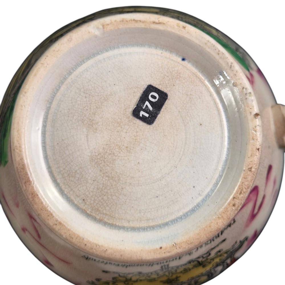 An antique cream earthenware jug featuring pink splash lustre decoration and a hand-coloured transfer print of Masonic coats of arms. View VIII