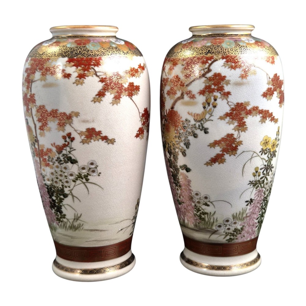 A pair of Japanese Satsuma earthenware vases decorated with intricate hand-painted floral motifs, autumn maple leaves, chrysanthemums, and gold accents over a crackle glaze. View II