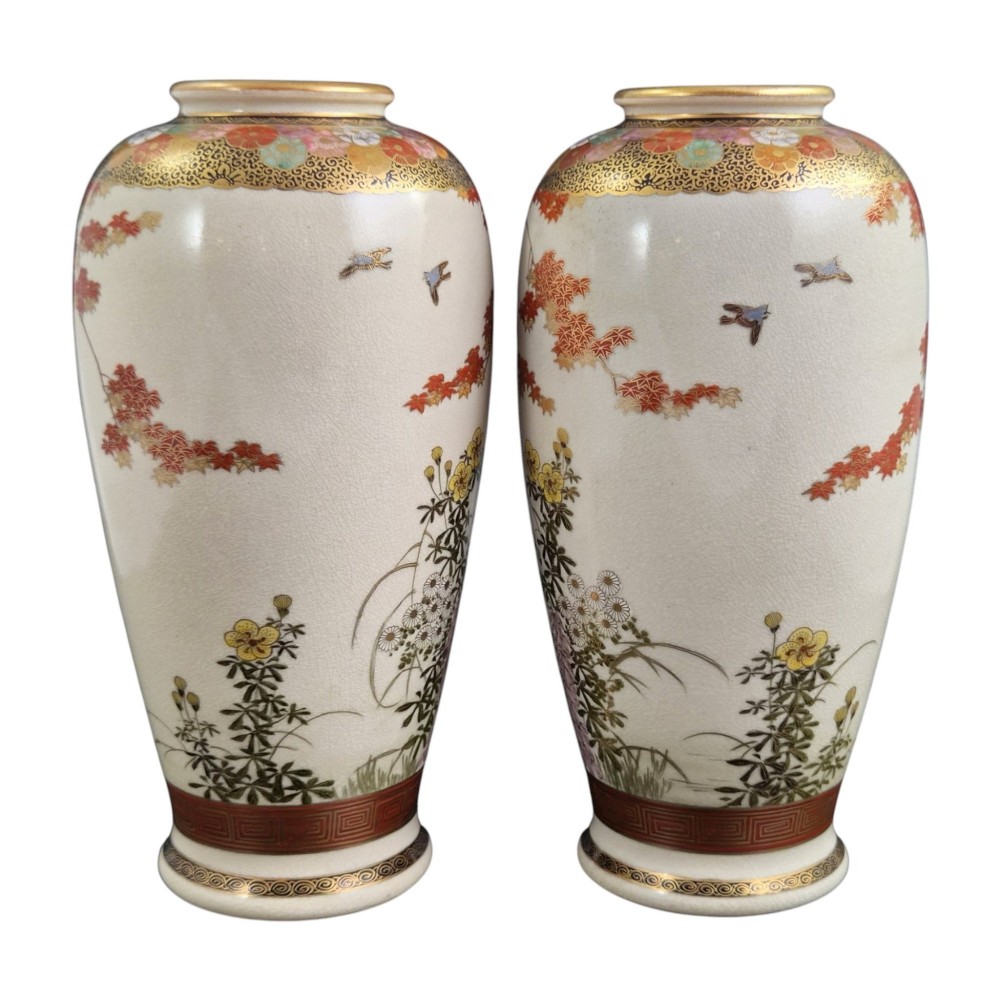 A pair of Japanese Satsuma earthenware vases decorated with intricate hand-painted floral motifs, autumn maple leaves, chrysanthemums, and gold accents over a crackle glaze. View IV