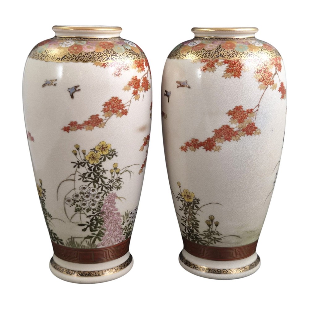 A pair of Japanese Satsuma earthenware vases decorated with intricate hand-painted floral motifs, autumn maple leaves, chrysanthemums, and gold accents over a crackle glaze. View V