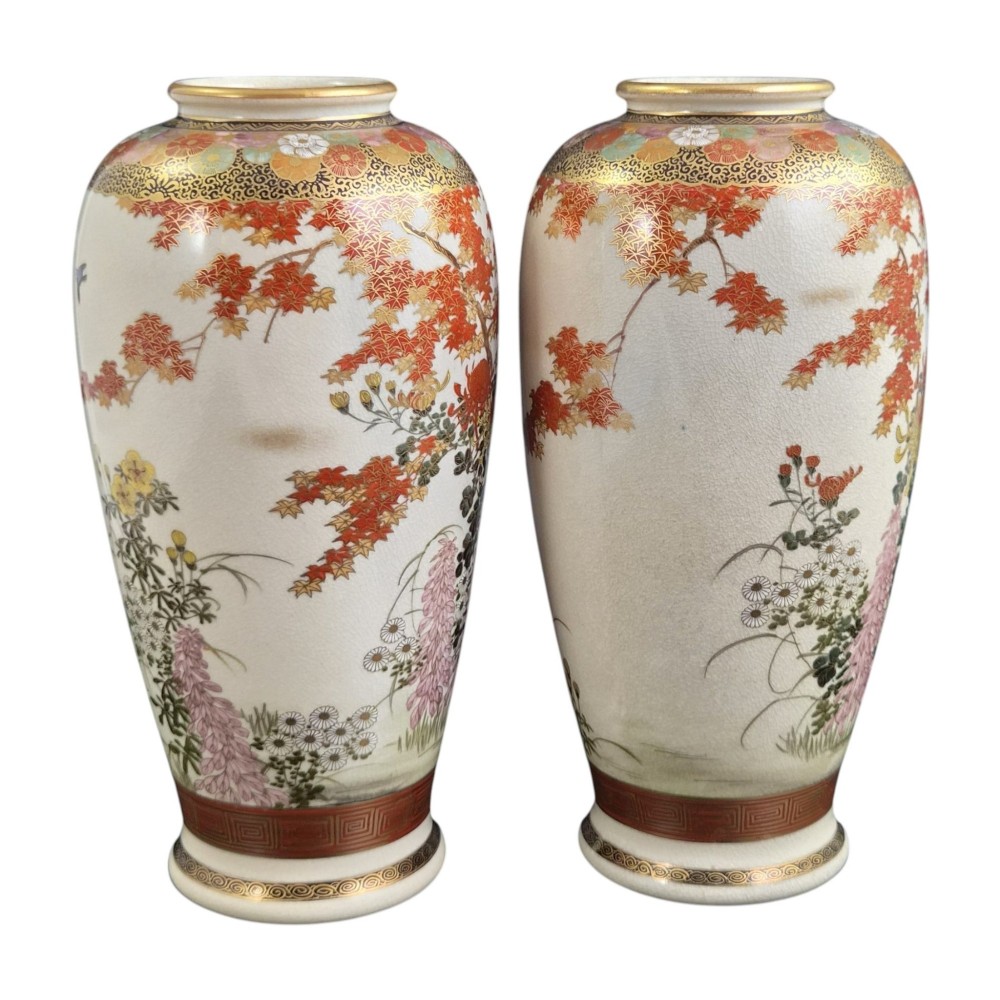A pair of Japanese Satsuma earthenware vases decorated with intricate hand-painted floral motifs, autumn maple leaves, chrysanthemums, and gold accents over a crackle glaze. View VI