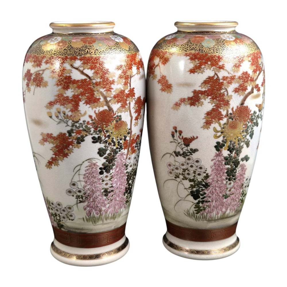 A pair of Japanese Satsuma earthenware vases decorated with intricate hand-painted floral motifs, autumn maple leaves, chrysanthemums, and gold accents over a crackle glaze. View VII