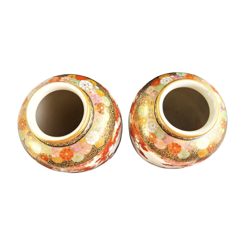 A pair of Japanese Satsuma earthenware vases decorated with intricate hand-painted floral motifs, autumn maple leaves, chrysanthemums, and gold accents over a crackle glaze. View VIII