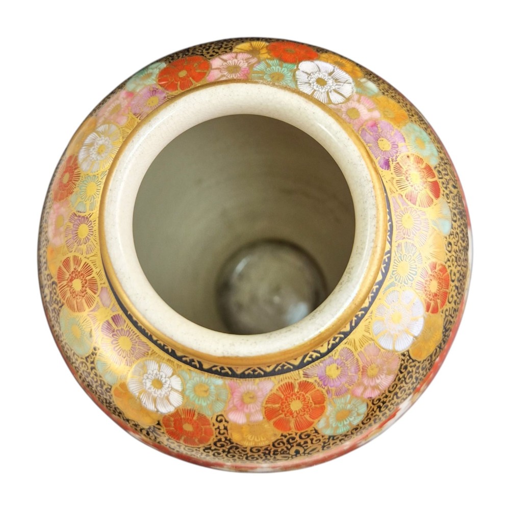 A pair of Japanese Satsuma earthenware vases decorated with intricate hand-painted floral motifs, autumn maple leaves, chrysanthemums, and gold accents over a crackle glaze. View X