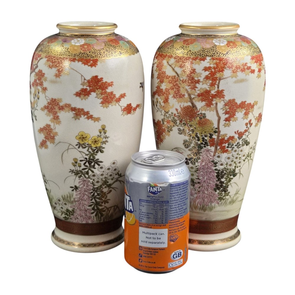 A pair of Japanese Satsuma earthenware vases decorated with intricate hand-painted floral motifs, autumn maple leaves, chrysanthemums, and gold accents over a crackle glaze. View XV