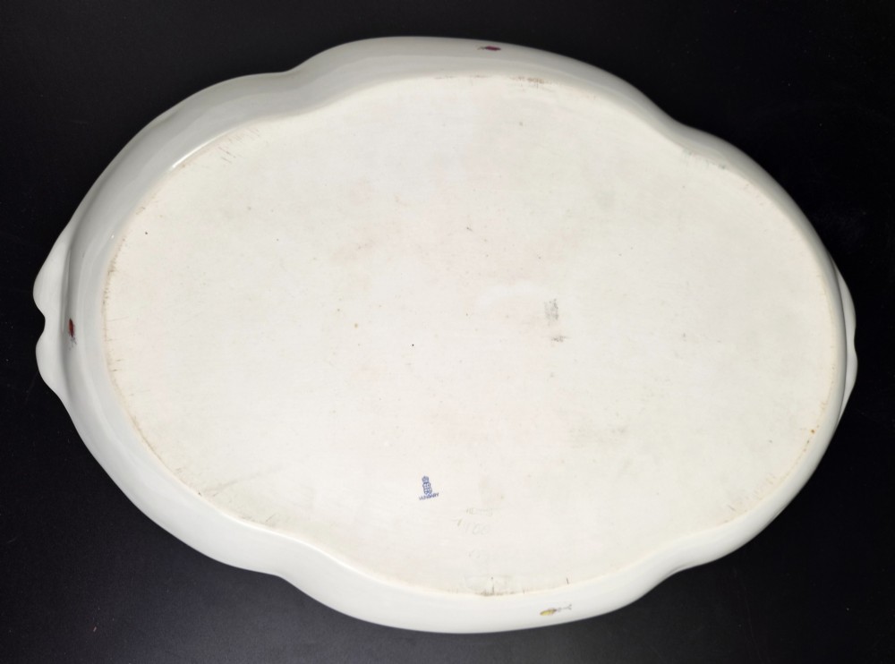An oval white porcelain tray featuring hand-painted fruit and insect motifs, moulded basketweave border, pink painted ribbon handles, and a gilded rim. View IX