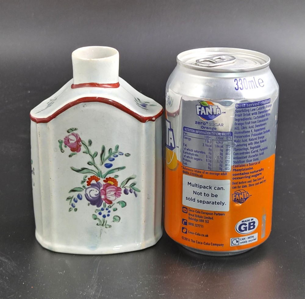 An eighteenth-century creamware tea canister with hand-painted floral enamel motifs in purple, red, and green on an off-white earthenware body with arched reddish-brown shoulders. View VIII