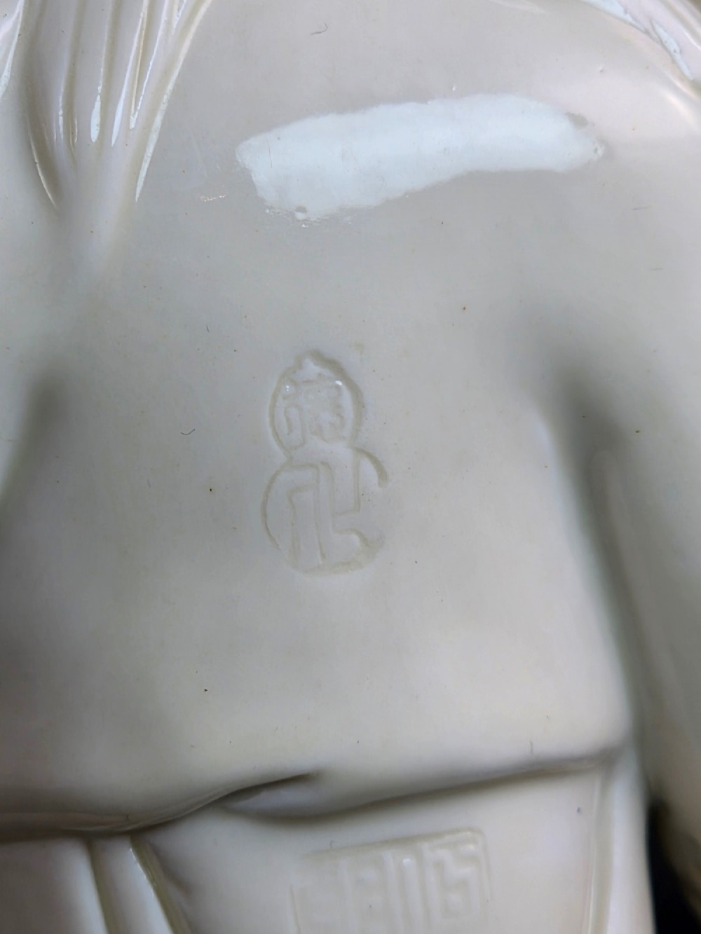 A Qing Dynasty Blanc-de-Chine white porcelain figure group depicting the Hehe Erxian standing on a stylised lotus and wave base. View XI