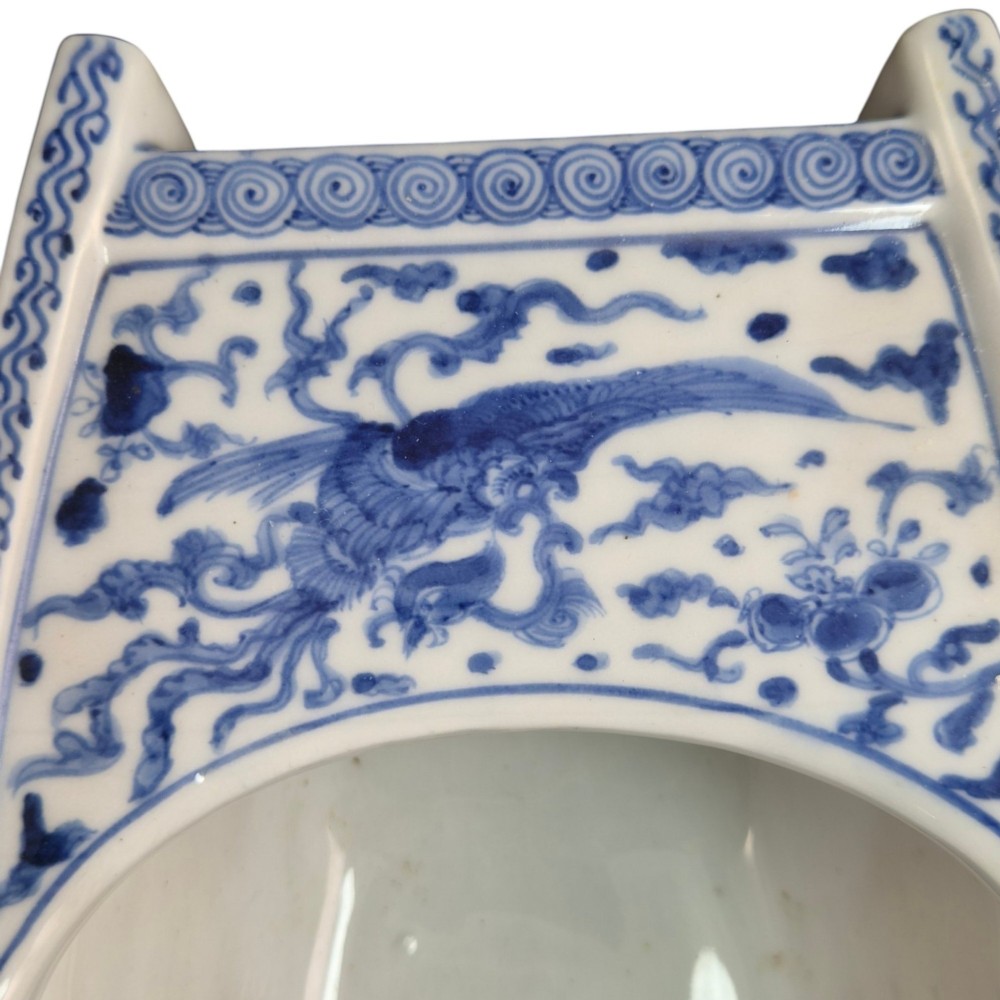 A Japanese blue and white porcelain vessel shaped like a boat featuring a carved dragon figurehead at the prow. View II