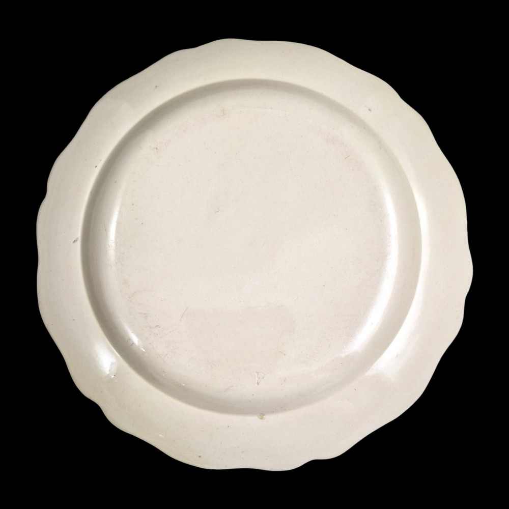 A pair of round cream-coloured earthenware plates featuring monochrome transfer prints of birds and moulded scalloped rims. View VIII