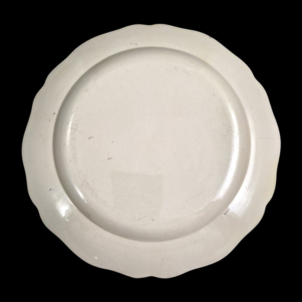 A pair of round cream-coloured earthenware plates featuring monochrome transfer prints of birds and moulded scalloped rims. View IX