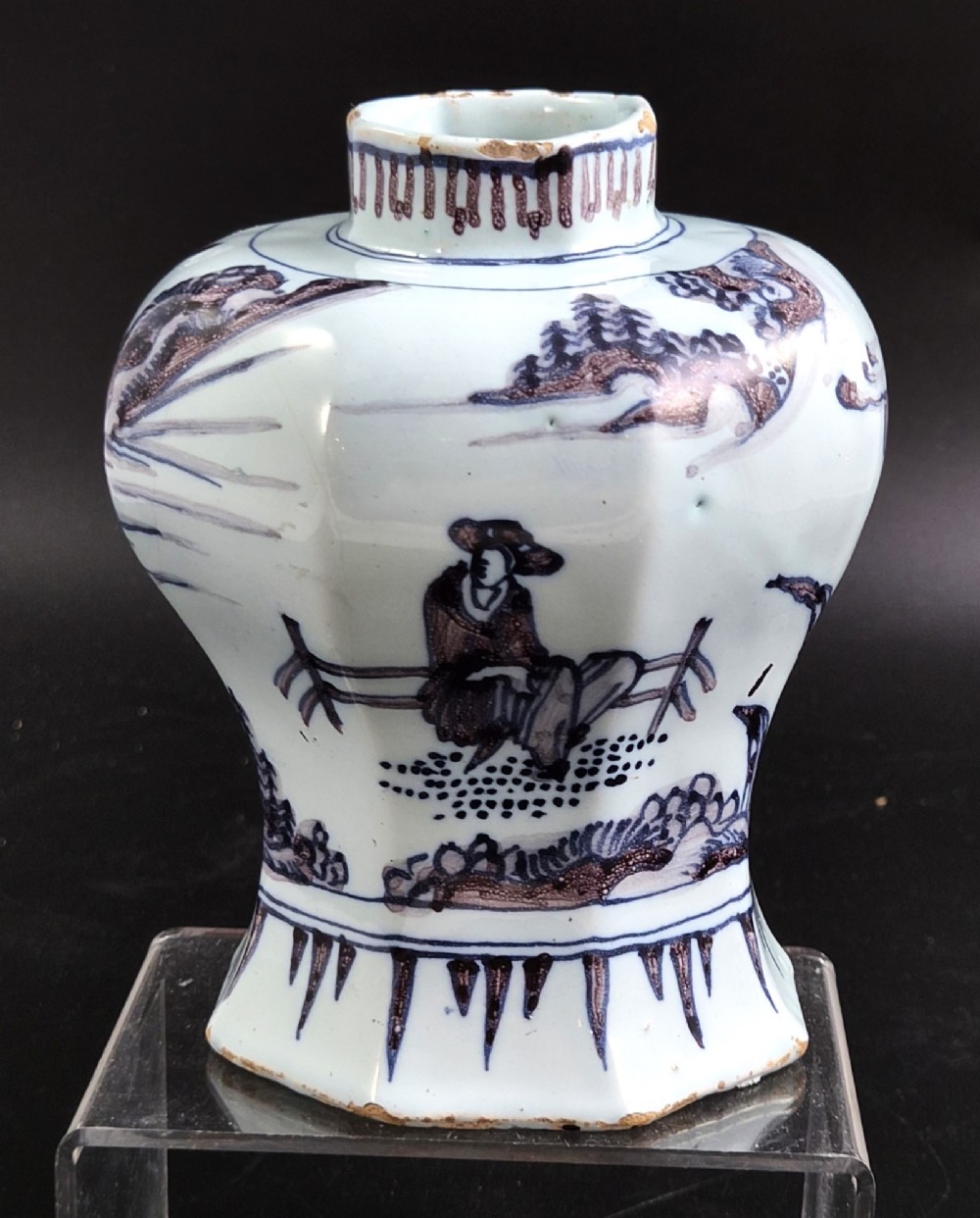 An octagonal antique Dutch Delft tin-glazed earthenware baluster vase painted in blue and manganese depicting a Chinese scholar.