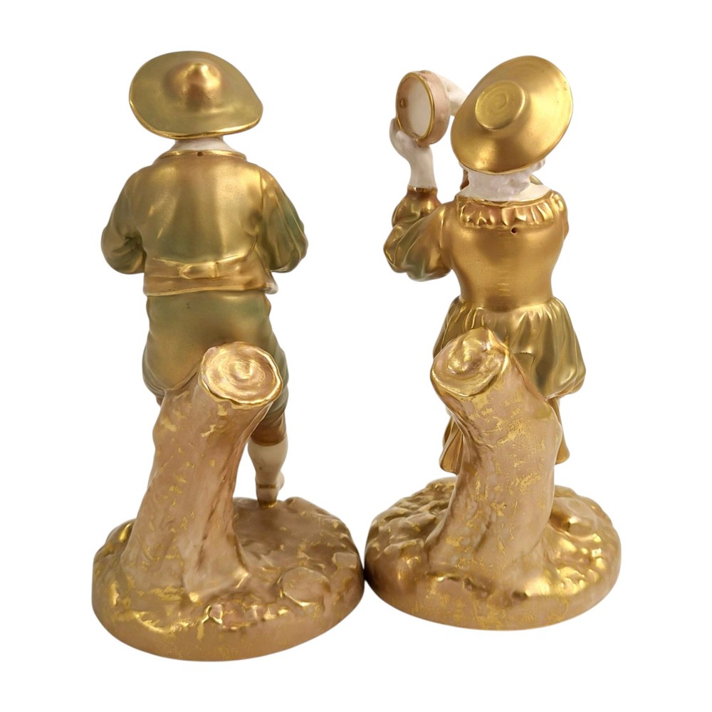 A pair of mid-century Royal Worcester bone china figurines depicting Strephon playing a pipe instrument and Phyllis playing a tambourine, finished in metallic gold and off-white porcelain. View III