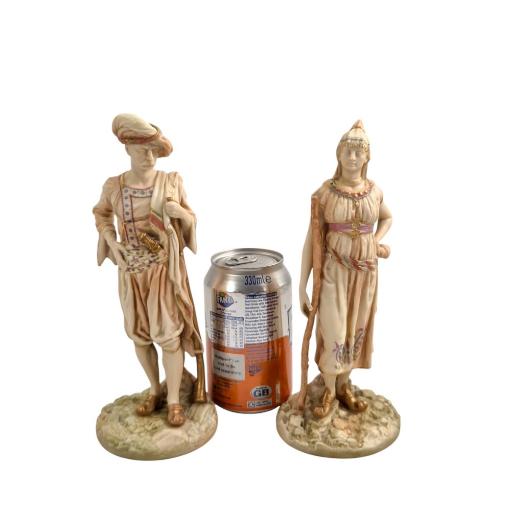 A pair of late Victorian Royal Worcester blush ivory porcelain figures depicting an Indian man and woman in detailed traditional attire with gilded accents. View XII