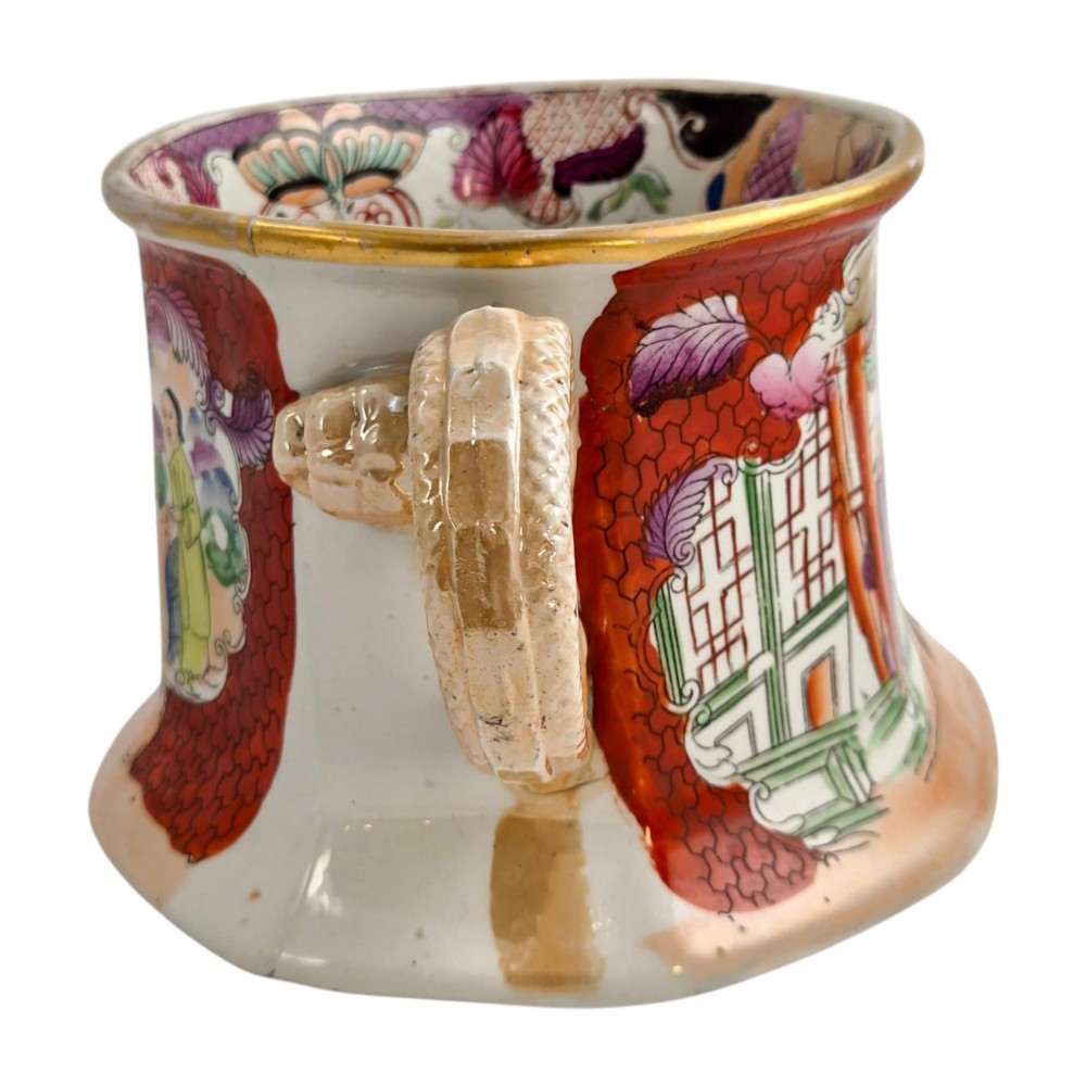 An antique Masons ironstone cider mug featuring a red scale background, hand-painted Chinoiserie panels, a flared base, and a sculpted hydra handle. View III
