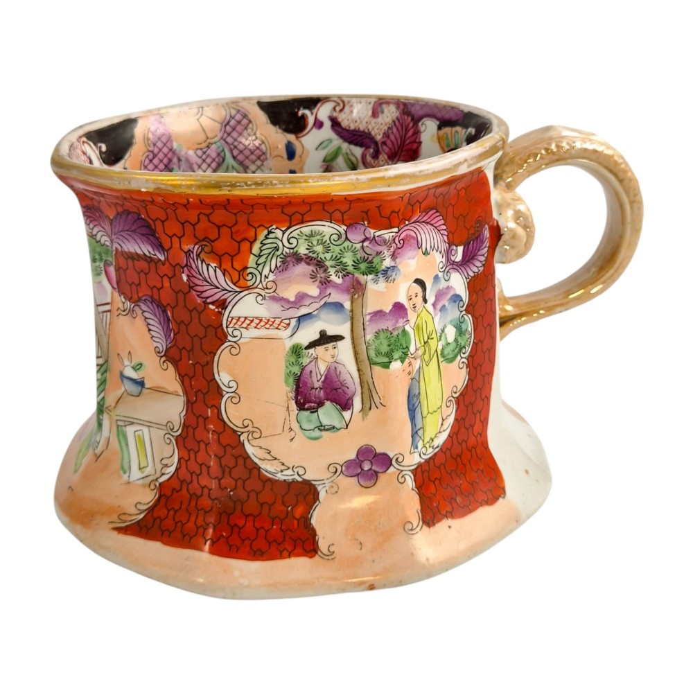 An antique Masons ironstone cider mug featuring a red scale background, hand-painted Chinoiserie panels, a flared base, and a sculpted hydra handle. View IX