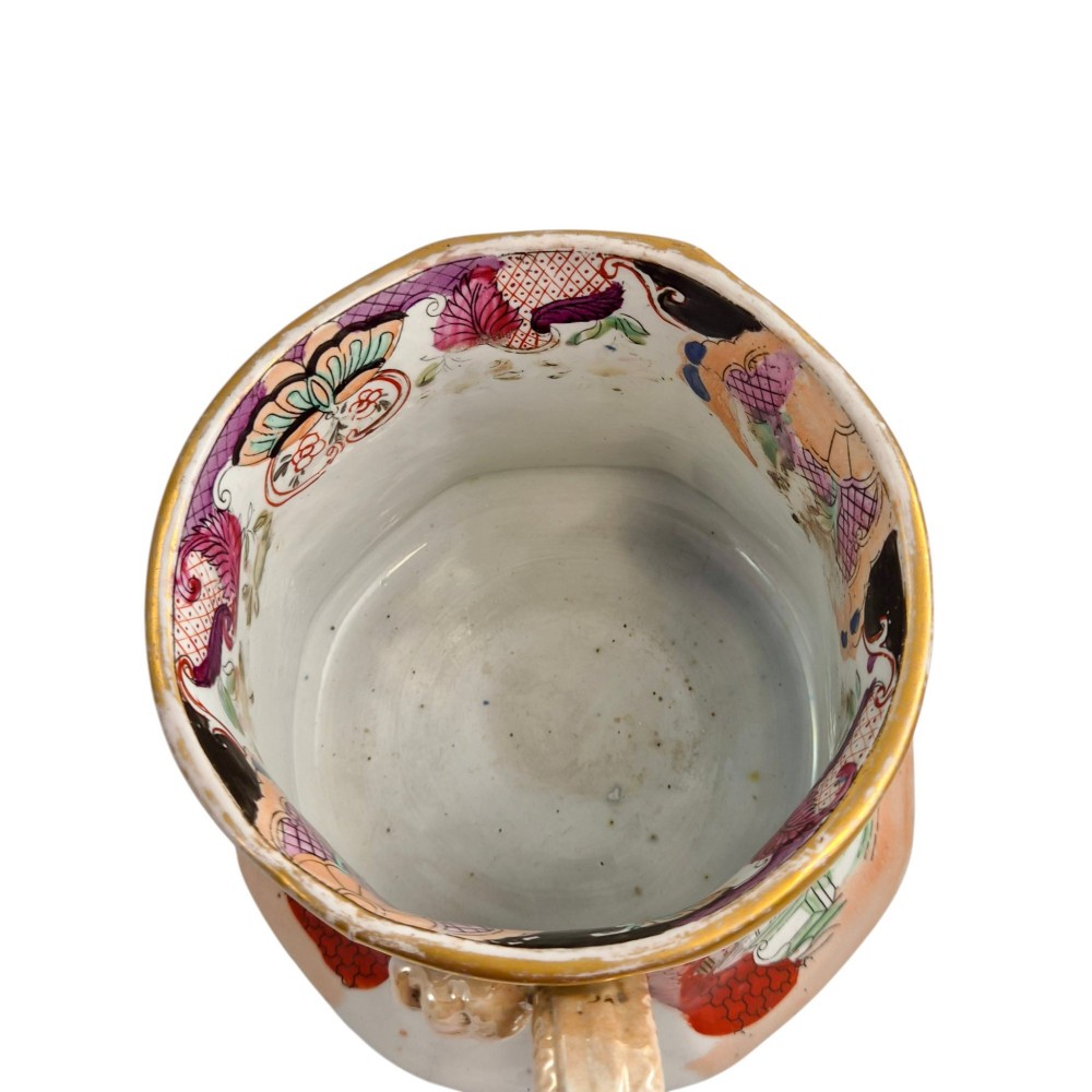 An antique Masons ironstone cider mug featuring a red scale background, hand-painted Chinoiserie panels, a flared base, and a sculpted hydra handle. View X