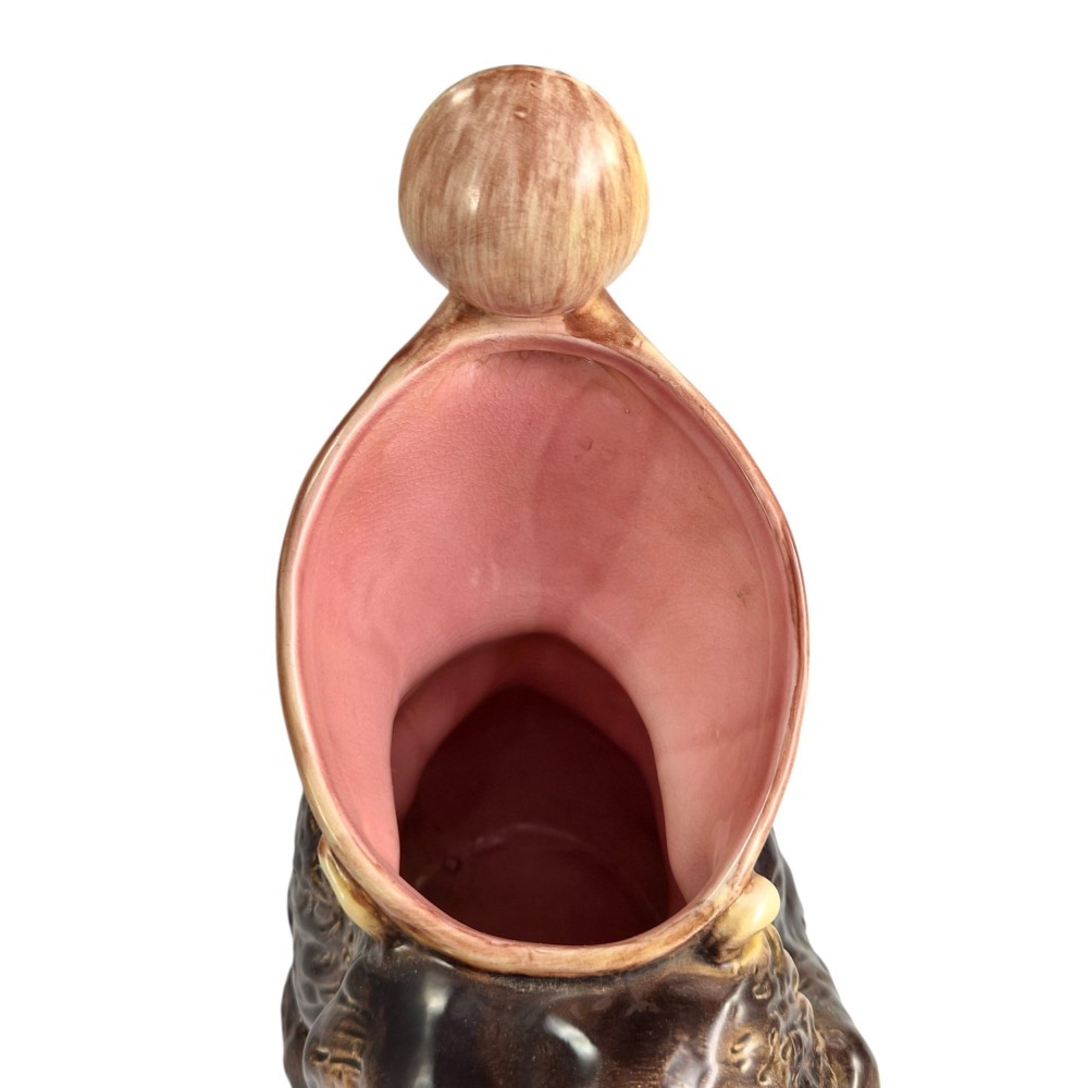 A set of three graduating Victorian majolica syrup jugs sculpted in the form of seated bears with pink glazed interiors. View V
