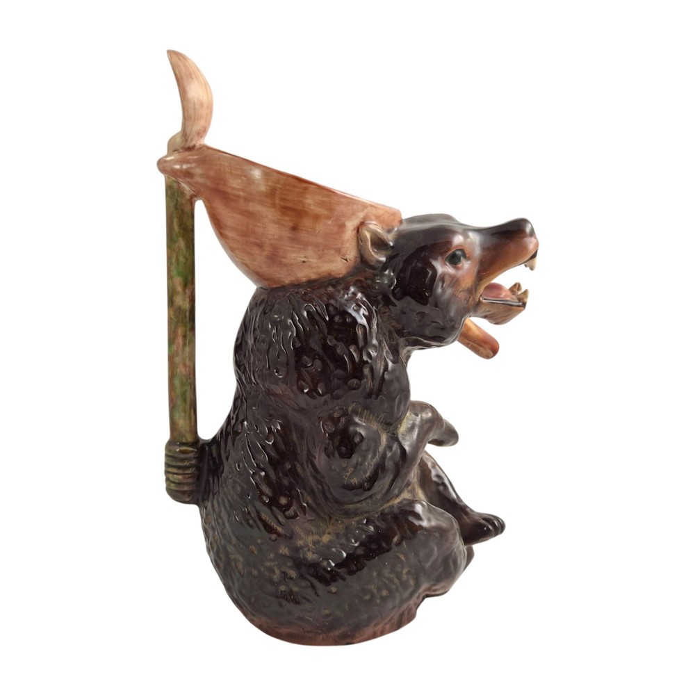 A set of three graduating Victorian majolica syrup jugs sculpted in the form of seated bears with pink glazed interiors. View VIII