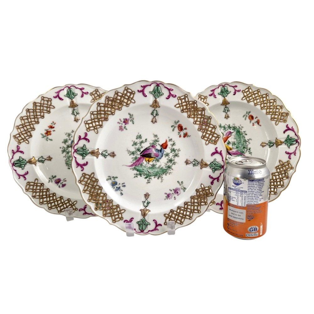Set of three white porcelain cabinet plates featuring pierced lattice rims decorated with gold gilding, pink scrolls, green accents, and hand-painted exotic birds in the centre. View II