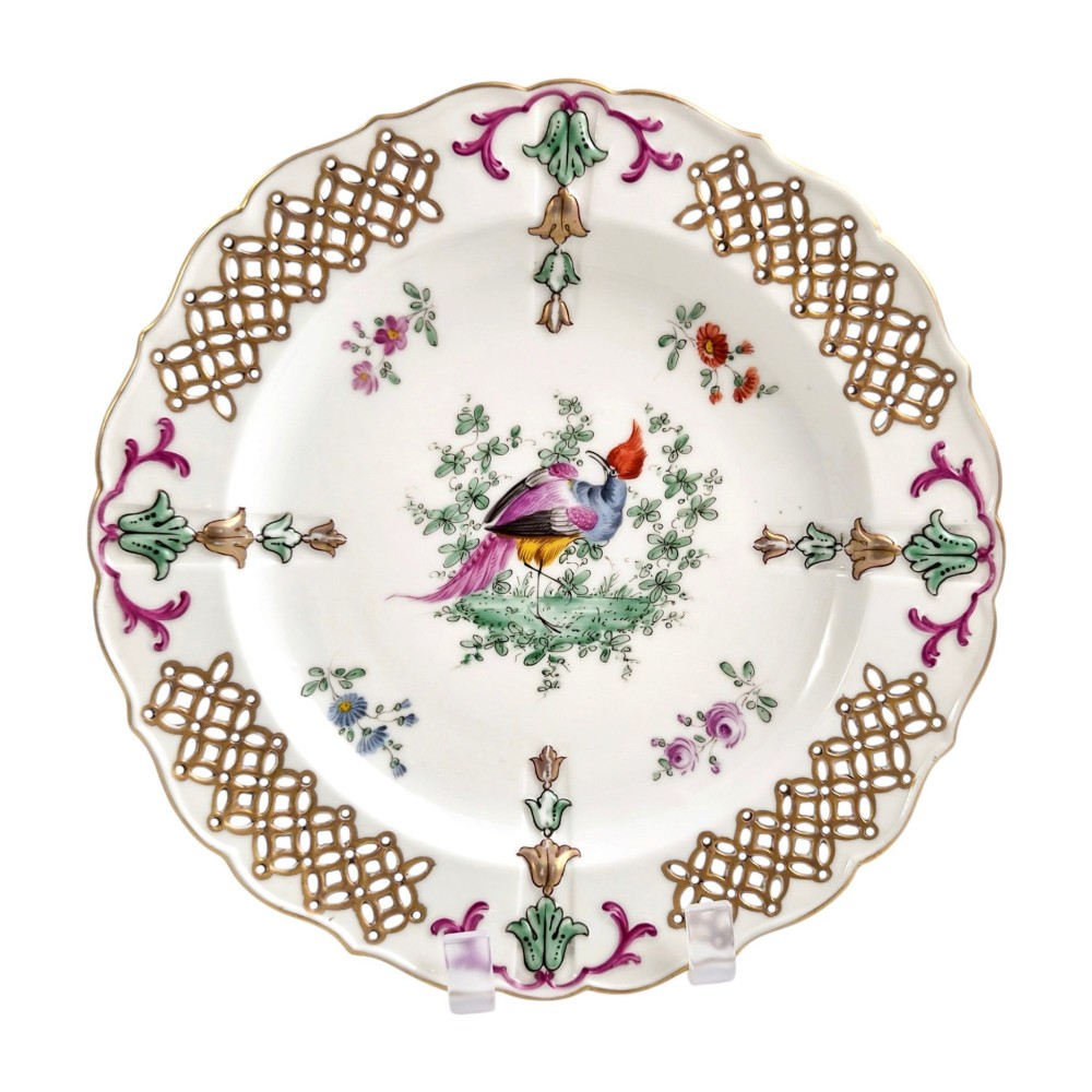 Set of three white porcelain cabinet plates featuring pierced lattice rims decorated with gold gilding, pink scrolls, green accents, and hand-painted exotic birds in the centre. View III