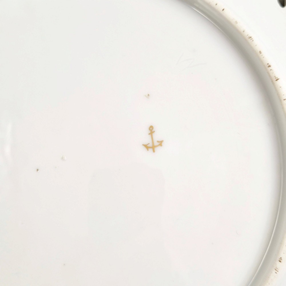 Set of three white porcelain cabinet plates featuring pierced lattice rims decorated with gold gilding, pink scrolls, green accents, and hand-painted exotic birds in the centre. View V