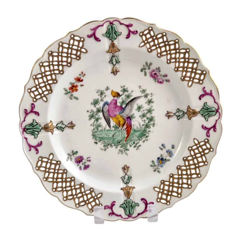 Set of three white porcelain cabinet plates featuring pierced lattice rims decorated with gold gilding, pink scrolls, green accents, and hand-painted exotic birds in the centre. View IX