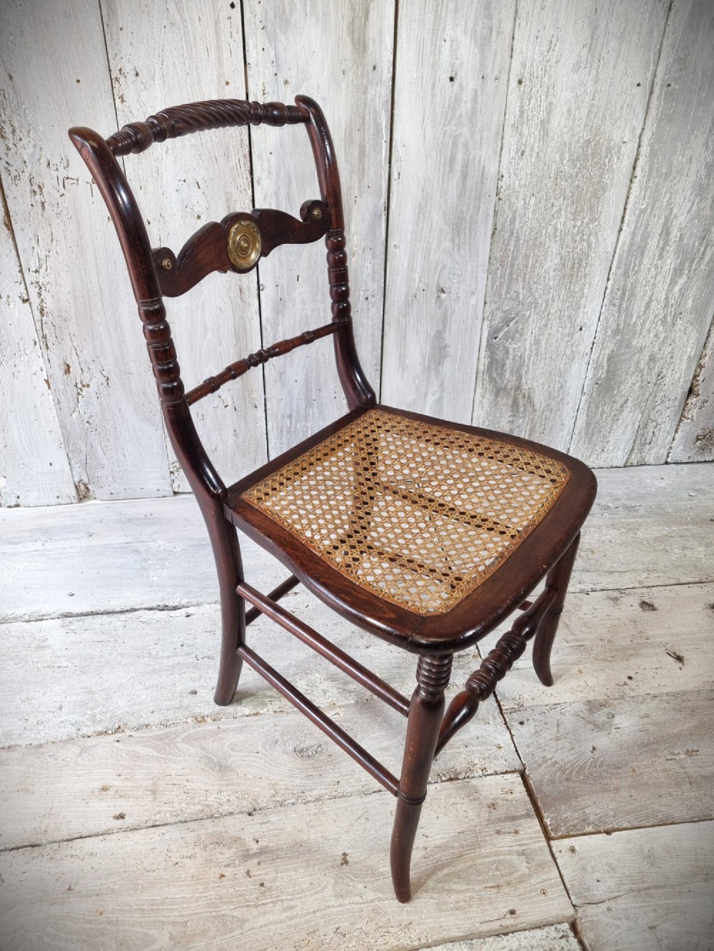 A Regency period side chair featuring a simulated rosewood finish, a rope-twist top rail, a brass-mounted centre splat, turned legs, and a hand-woven cane seat. View III