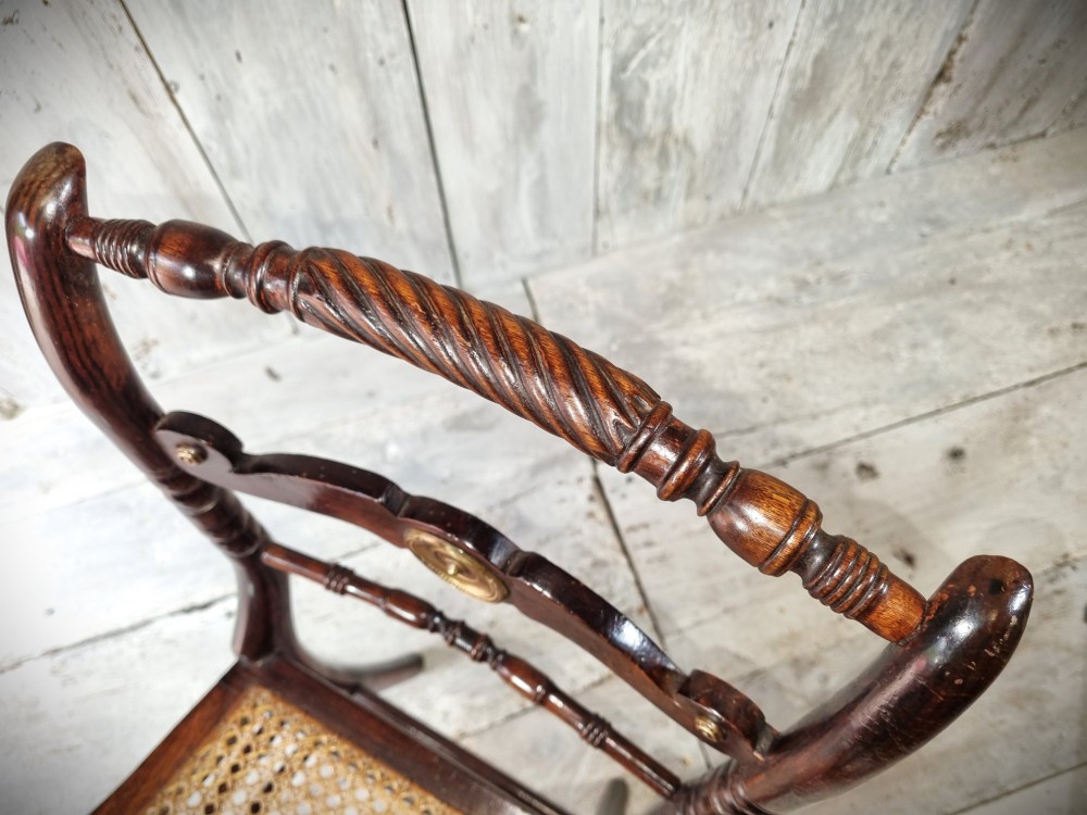 A Regency period side chair featuring a simulated rosewood finish, a rope-twist top rail, a brass-mounted centre splat, turned legs, and a hand-woven cane seat. View VII