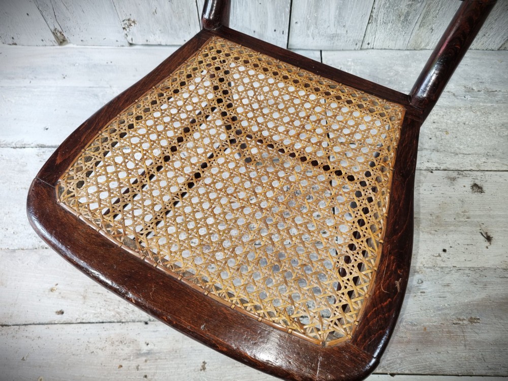 A Regency period side chair featuring a simulated rosewood finish, a rope-twist top rail, a brass-mounted centre splat, turned legs, and a hand-woven cane seat. View VIII