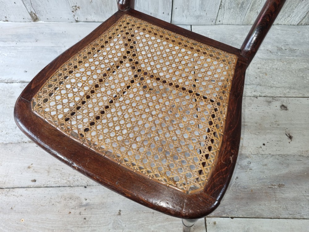 A Regency period side chair featuring a simulated rosewood finish, a rope-twist top rail, a brass-mounted centre splat, turned legs, and a hand-woven cane seat. View IX