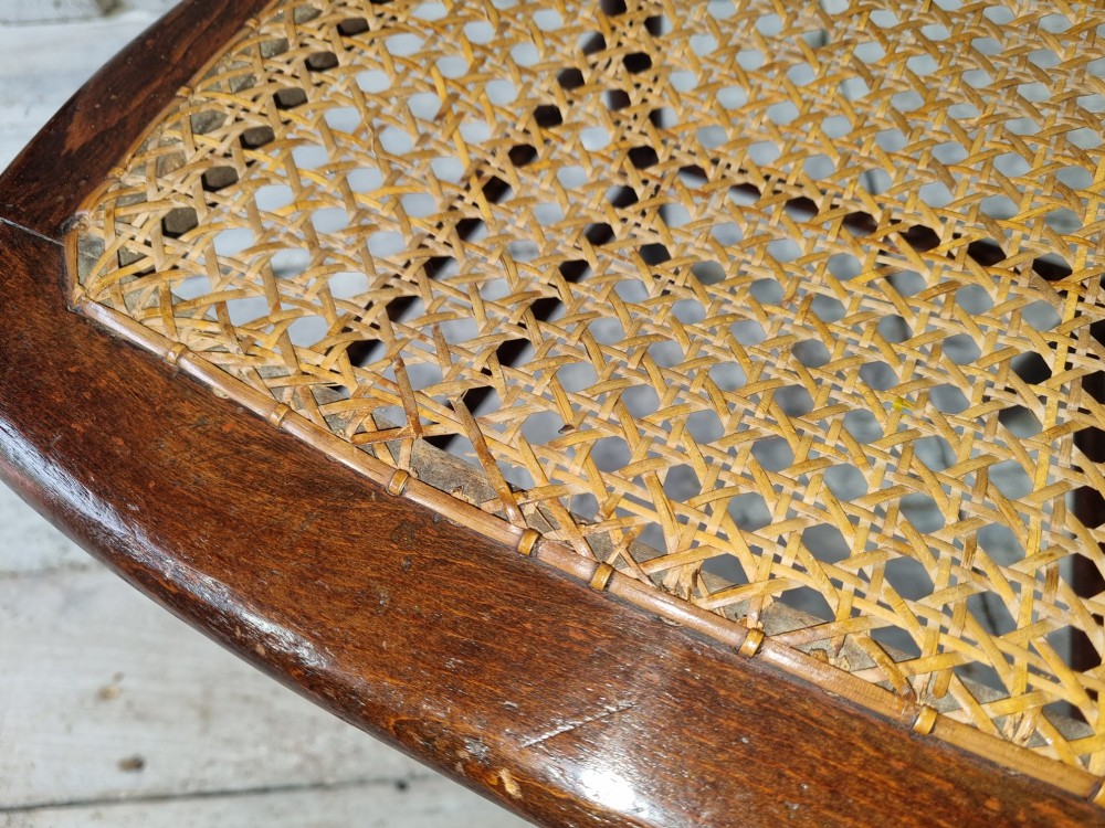 A Regency period side chair featuring a simulated rosewood finish, a rope-twist top rail, a brass-mounted centre splat, turned legs, and a hand-woven cane seat. View X