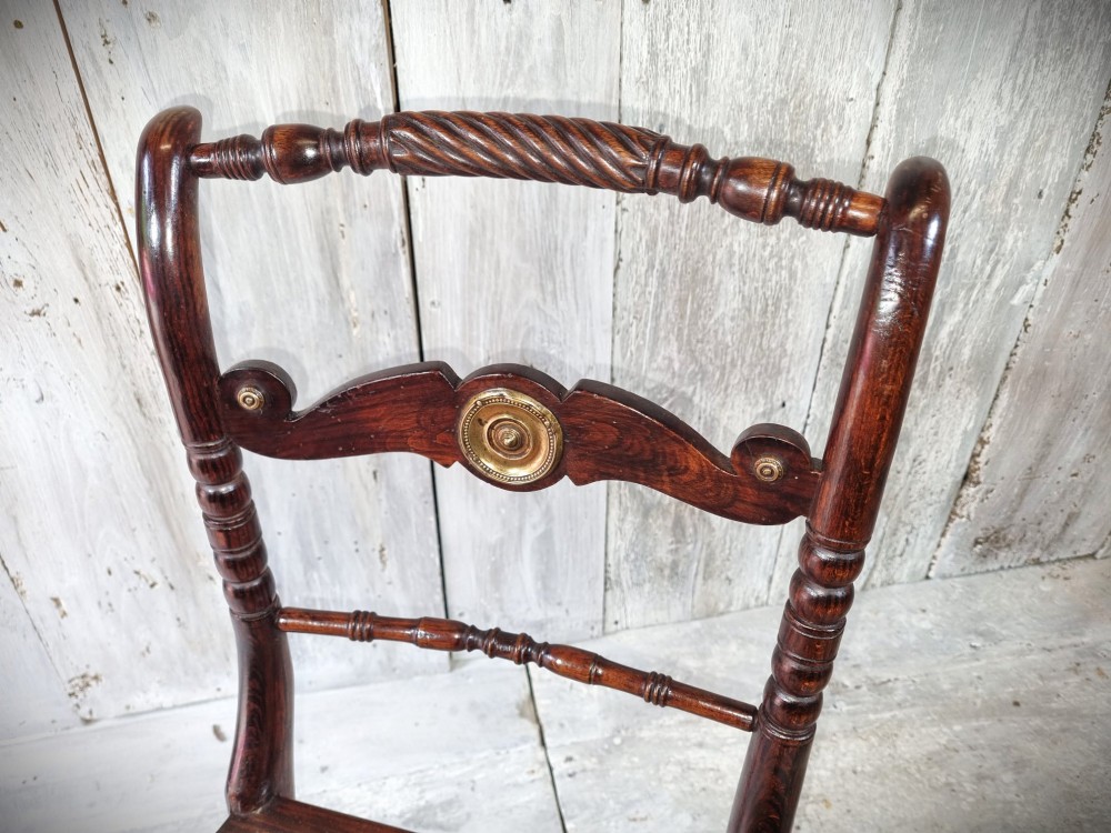 A Regency period side chair featuring a simulated rosewood finish, a rope-twist top rail, a brass-mounted centre splat, turned legs, and a hand-woven cane seat. View XI
