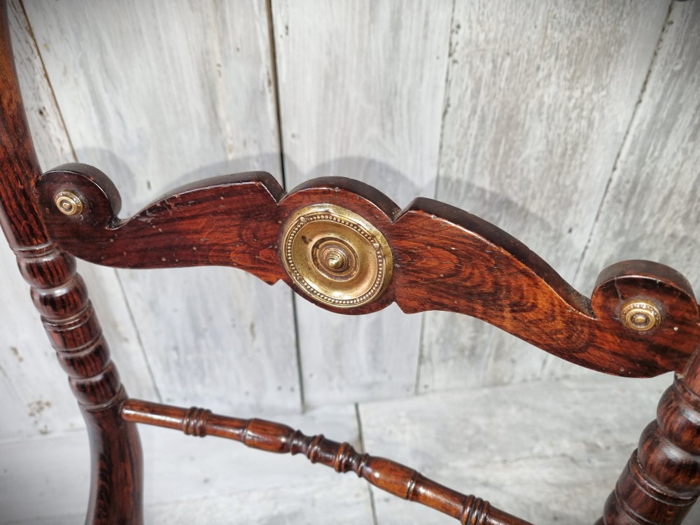 A Regency period side chair featuring a simulated rosewood finish, a rope-twist top rail, a brass-mounted centre splat, turned legs, and a hand-woven cane seat. View XII