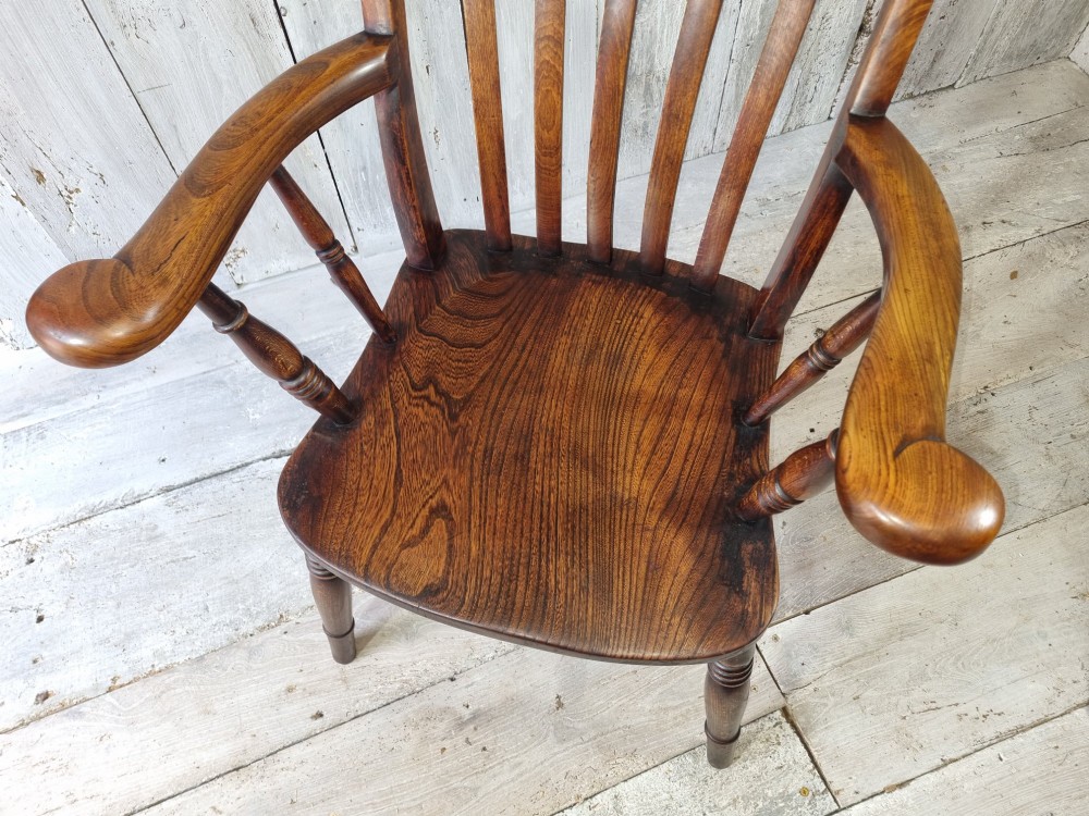 A Victorian lath back Windsor armchair crafted from warm brown polished wood with a shaped elm seat and turned beech legs. View IX