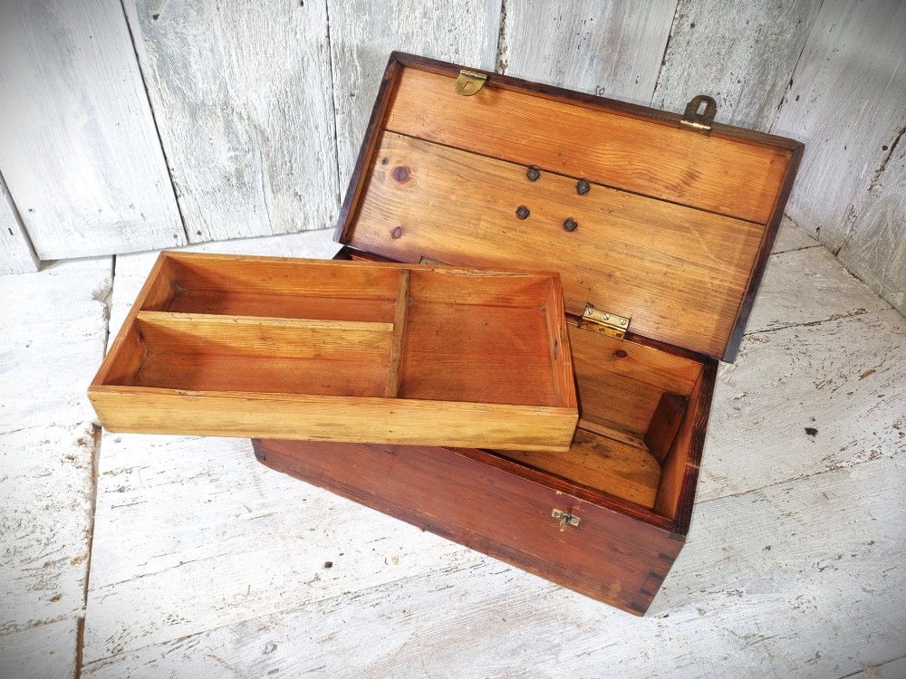 A rectangular warm brown wooden tool box featuring white stencilled text, a central winged logo, and an iron top clasp. View XII