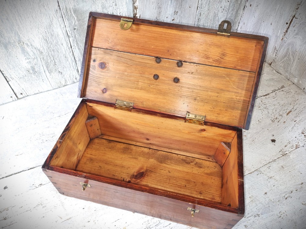 A rectangular warm brown wooden tool box featuring white stencilled text, a central winged logo, and an iron top clasp. View XIII