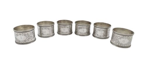 fig 1. A fitted velvet-lined presentation case containing a set of six cylindrical sterling silver napkin rings decorated with floral engravings.