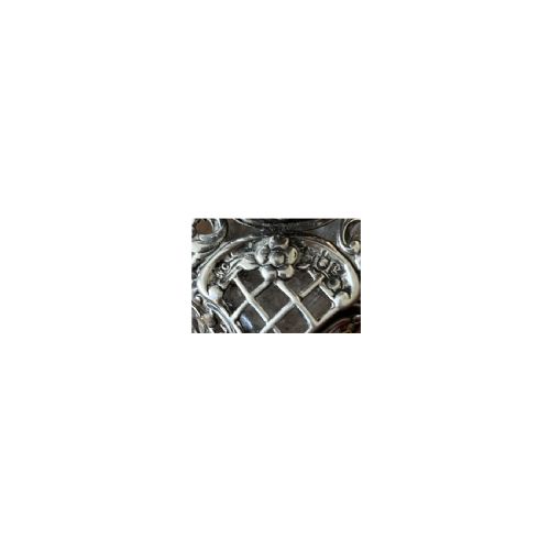 fig 1. An Edwardian cut glass scent bottle encased in elaborate sterling silver floral scrollwork overlay with a hinged silver cap.