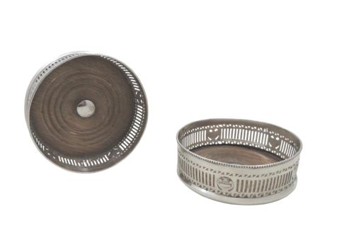 fig 1. A pair of circular Edwardian sterling silver wine bottle coasters featuring pierced galleries with urn medallions and turned wooden bases.