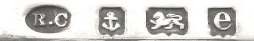 fig 1. An Edwardian sterling silver rectangular trinket box featuring floral repousse scrollwork on the hinged lid, fluted sides, and small cast feet.