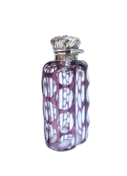 An Edwardian purple overlay cut glass scent bottle with oval clear cutouts and an embossed sterling silver cap. View V