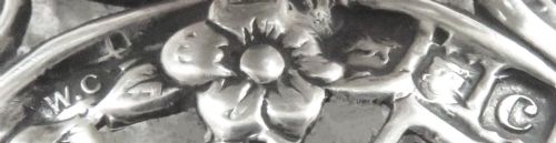 fig 1. An antique Victorian clear cut-glass inkwell featuring an intricate repousse sterling silver collar and hinged lid.