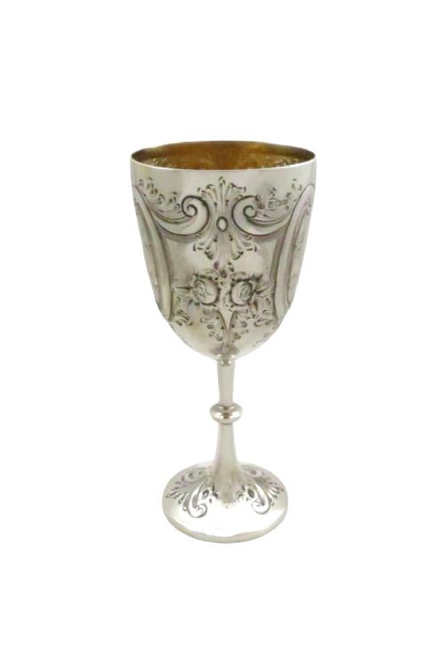 An Edwardian sterling silver wine goblet featuring scroll repousse engraving, an unengraved central cartouche, a knopped stem, and a gilt interior. View IV