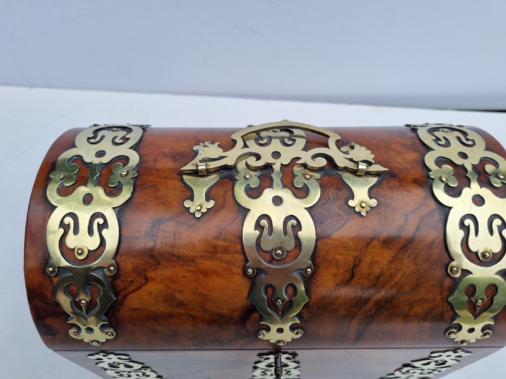 A Victorian walnut dome top stationery box featuring decorative pierced brass strapwork mounts and keyhole escutcheon. View V