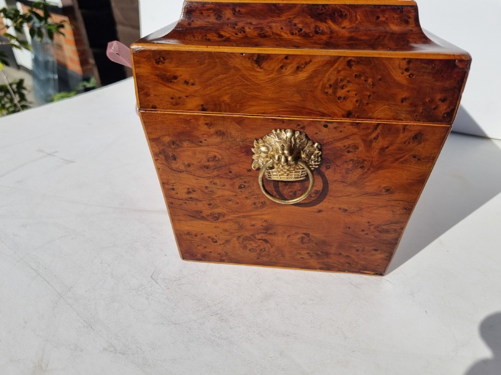 A Georgian burr yew tea caddy featuring a sarcophagus-shaped lid, boxwood stringing inlay, and a central keyhole escutcheon. View III