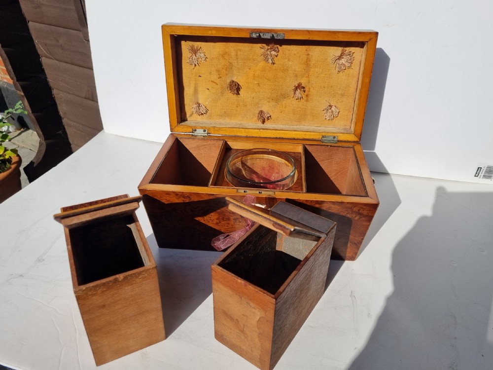 A Georgian burr yew tea caddy featuring a sarcophagus-shaped lid, boxwood stringing inlay, and a central keyhole escutcheon. View VIII