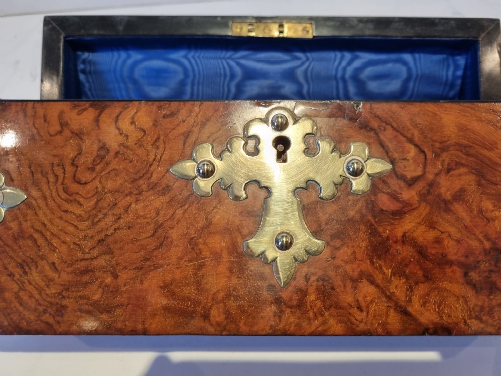 A Victorian burr walnut stationery box with a dome lid, ornamented with pierced brass mounts and a decorative brass keyhole escutcheon. View VII